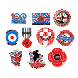 May include: A collection of ten metal enamel pins featuring commemorative military and remembrance themes. Designs include the Union Jack, red poppies, silhouettes of soldiers, the Royal Air Force roundel, and text such as Lest We Forget, 100 Years, and Born to Ride British.