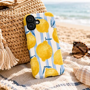 May include: A phone case featuring a pattern of bright yellow lemons with green leaves against a background of vertical light blue and white stripes. The case has a black camera cutout area and a smooth finish, showcasing a vibrant fruit design.
