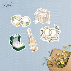 May include: A set of five wedding-themed stickers featuring an infinity symbol with roses and rings, a gift box with a bow, a diamond ring in a green box, a champagne bottle labeled Wedding Toast, and two rings with the text Always & Forever.