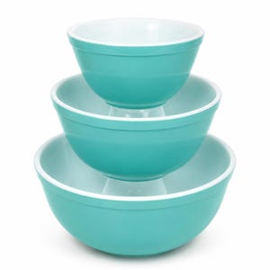 Peut inclure: Un ensemble de trois bols gigognes empilés verticalement. Chaque bol présente un extérieur turquoise uni et lisse avec un intérieur blanc contrastant. Les bols ont une forme arrondie avec un bord simple, de taille croissante vers le bas.