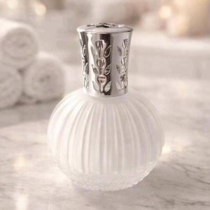 May include: A round, frosted glass fragrance lamp with a ribbed texture and a silver-coloured metal crown top featuring cut-out tulip motifs. The base is spherical and translucent, while the metallic cap sits securely on the neck of the vessel.
