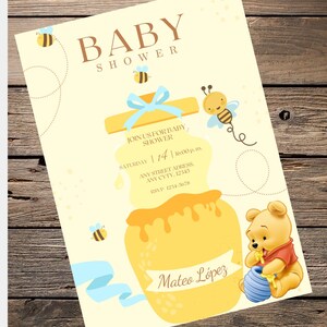 May include: Baby shower invitation featuring a honey pot with dripping honey, a cartoon bear, and bees. The invitation includes the text "Baby Shower", "Join us for Baby Shower", date, time, address, and RSVP information. The invitation is personalized with the name "Mateo López".