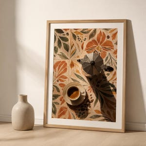 May include: A framed art print featuring a coffee setup. The artwork showcases a coffee cup and a stovetop espresso maker on a floral tile background. The color palette includes orange, green, and beige tones. A beige vase is in the foreground.
