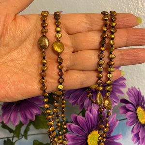 Pearl necklace. 60 inches of golden copper freshwater Pearls with a lobster claw clasp.