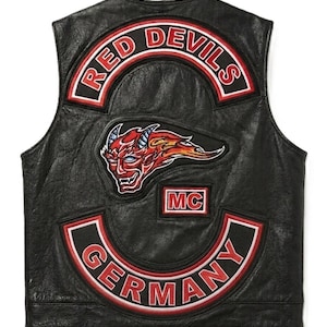 Könnte beinhalten: Schwarze Lederweste mit "Red Devils"-Patches. Die Weste hat eine Teufelsgrafik und den Text "MC". Die Patches haben ein rot-weiß-schwarzes Farbschema mit dem Text "Germany" auf dem unteren Patch.