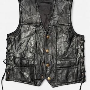 May include: A black leather vest constructed from multiple stitched panels, featuring a V-neckline, four gold-toned metal buttons down the front, and black leather laces threaded through metal eyelets along both side seams for adjustable fit.