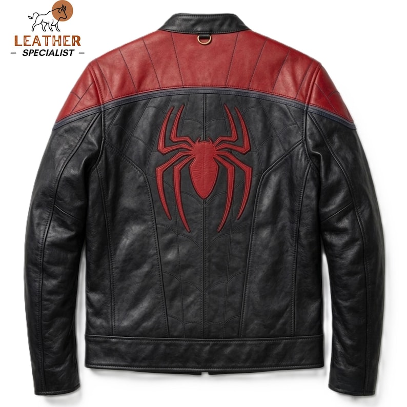 May include: A black and red leather jacket featuring a prominent red spider emblem centred on the back. The jacket has a stand-up collar with a small metal ring detail, long sleeves, and a panelled construction with visible stitching throughout.