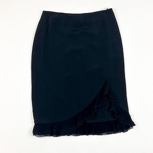 May include: A black skirt with a ruffled hem. The skirt is knee-length and has a fitted silhouette.