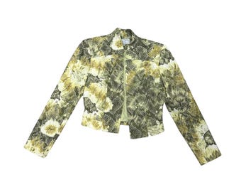 May include: A cropped jacket featuring a green and yellow snakeskin-inspired pattern with a central zipper closure, a high collar, and long sleeves. The garment has a structured fit with visible seams and a light green interior lining visible at the front.