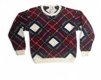 May include: A vintage crew neck sweater with a classic argyle pattern. The sweater features a red, navy, and cream color scheme with diamond shapes. The cuffs and neckline are cream-colored. A cozy, warm, and stylish garment.