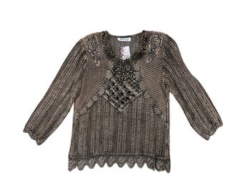 May include: A brown and black long-sleeve sweater with a decorative neckline and scalloped hem. The sweater has a textured knit pattern and the brand name "PACCO" is visible on a tag.