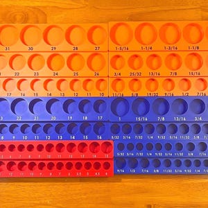 May include: A white ceramic mug with a black handle and the text "But First, Coffee" in a black, handwritten-style font. The mug is on a white surface.