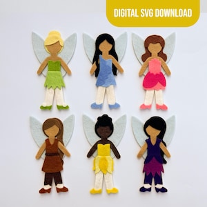 May include: Six felt fairy cutouts with light blue wings, each wearing a different colored dress including green, blue, pink, brown, yellow, and purple. The figures have varied hair colors and styles. Text at the top reads DIGITAL SVG DOWNLOAD.