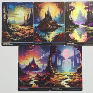 May include: Five rectangular trading cards featuring vibrant fantasy landscapes. Each card displays a unique scene with a central castle or structure, glowing moons or suns, and colorful terrain including forests, swamps, mountains, and islands.