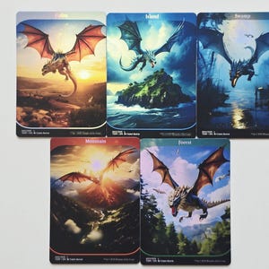 May include: Five rectangular trading cards featuring fantasy dragon illustrations. The cards are labeled Plains, Island, Swamp, Mountain, and Forest. Each card displays a unique dragon in flight over a landscape corresponding to its specific terrain type.