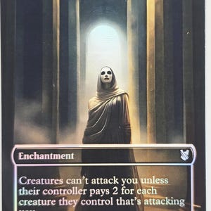 May include: A Magic: The Gathering card named "Ghostly Prison." The card shows a robed figure with a mask in a stone corridor. The card text states "Creatures can't attack you unless their controller pays 2 for each creature they control that's attacking you."