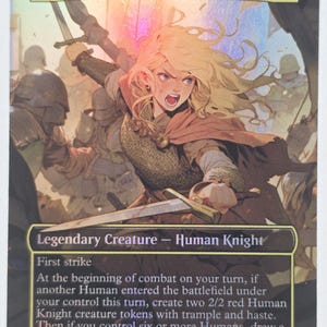 May include: A collectible trading card featuring Eowyn, Shieldmaiden, a blonde warrior in chainmail and a red cloak holding a sword. The card text identifies it as a Legendary Creature - Human Knight with a 5/4 power and toughness rating.