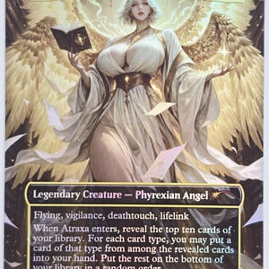 May include: A collectible trading card featuring Atraxa, Grand Unifier. The card depicts a female angel with large golden wings, holding a book and wearing a white and gold gown. Text includes "Legendary Creature - Phyrexian Angel" and card abilities.