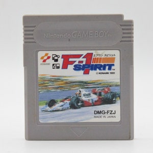 May include: A gray Game Boy cartridge with a red, white, and blue F1 Spirit logo. The cartridge is labeled "KONAMI 1991" and "DMG-FZJ".