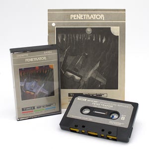 May include: An image of a vintage video game cassette tape, box, and manual. The game is titled "PENETRATOR" and was made for the Timex Sinclair personal color software. The box and tape feature a spaceship graphic. The manual is a gray color.