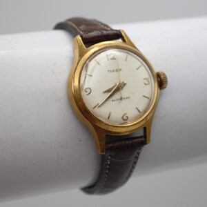 Vintage Timex gold tone watch bracelet mechanical wound movement round dial brown leather band wristwatch women's jewelry