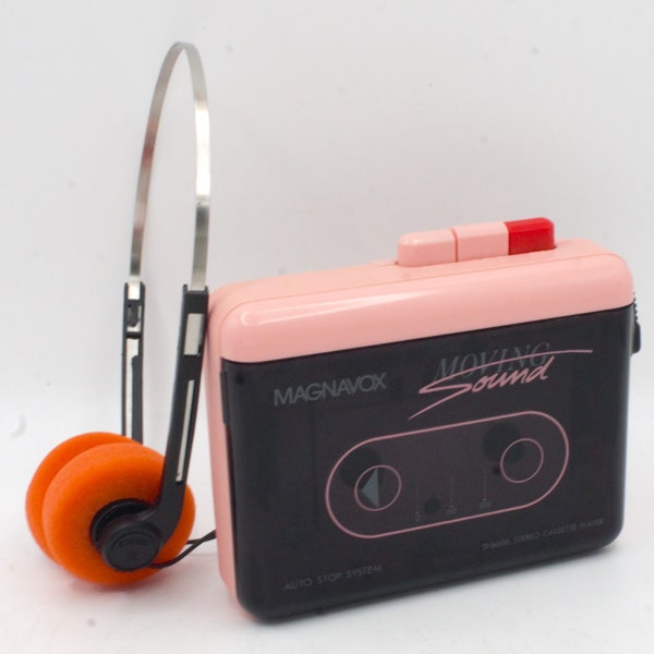 Vintage 1980s stereo cassette tape player in pink mod retro style headphones Magnavox Moving Sound portable audio