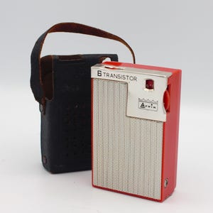 May include: A red and silver 6 transistor portable radio with a black leather carrying case. The radio has a silver dial with a white background and the text "Arvin" in silver lettering. The radio also has a red knob on the side.
