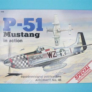 May include: A vintage book cover featuring a detailed illustration of a P-51 Mustang fighter plane in flight. The cover is titled "P-51 Mustang in action" and is part of the "Squadron/Signal Publications Aircraft No. 45" series. The book also features the text "Special 8 Extra Pages".