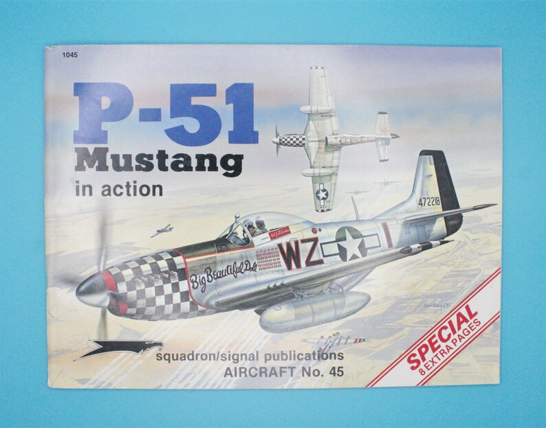May include: A vintage book cover featuring a detailed illustration of a P-51 Mustang fighter plane in flight. The cover is titled "P-51 Mustang in action" and is part of the "Squadron/Signal Publications Aircraft No. 45" series. The book also features the text "Special 8 Extra Pages".