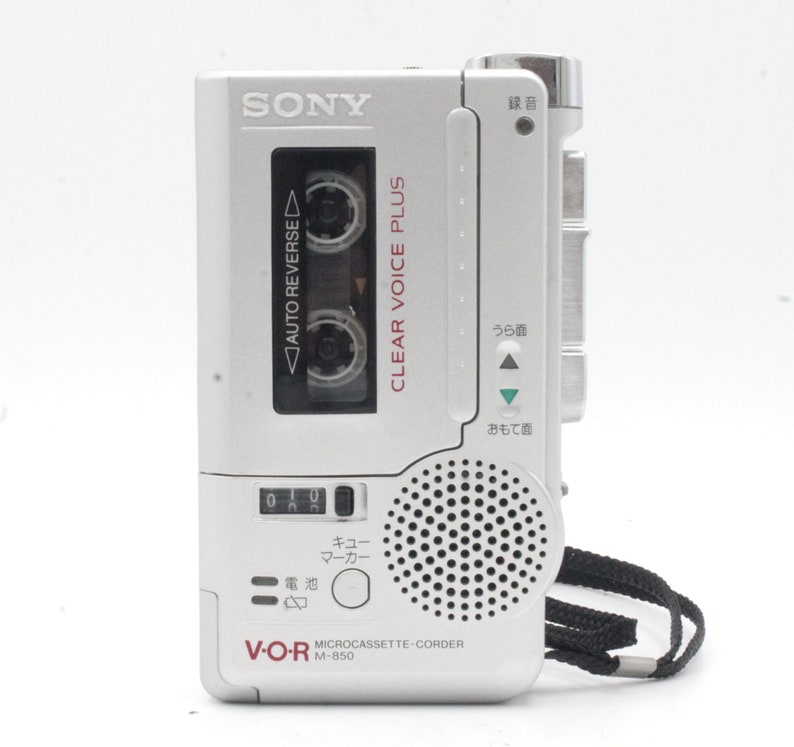 May include: A silver Sony V-O-R M-850 microcassette recorder with a clear voice plus feature. The recorder has a built-in speaker and a microphone.