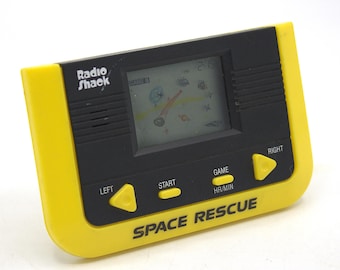 Vintage 1980s Space Rescue handheld video game LCD quartz digital sound 80s retro gaming tech cosmic arcade combat black yellow Radio Shack