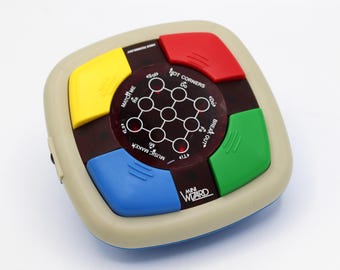 Vintage 1970s handheld game Mini Wizard Video Technology red LED light and digital sound electronic puzzle game