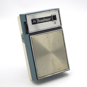 May include: A vintage blue and silver AM radio with the text "The Broadmoor" on the front.