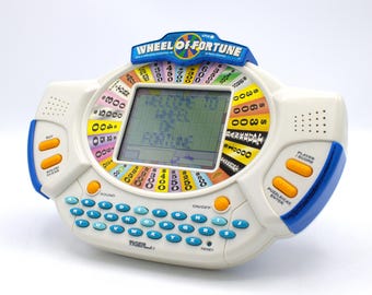 Vintage Wheel of Fortune handheld videogame replaceable cartridge system digital voice sound Classic television Game Show Tiger Games 1998