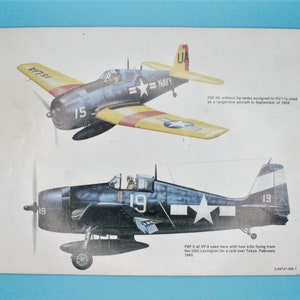 May include: Two illustrations of a blue and yellow Grumman F6F-5K Hellcat fighter plane. The top plane is yellow with red stripes and the bottom plane is blue with a white star. The text on the image reads "F6F-SK without tip tanks assigned to VU-1 is used as a target tow aircraft in September of 1959." and "F6F-5 of VF-9 seen here with four kills flying from the USS Lexington for a raid over Tokyo. February 1945."