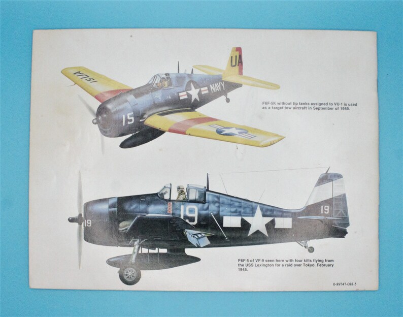 May include: Two illustrations of a blue and yellow Grumman F6F-5K Hellcat fighter plane. The top plane is yellow with red stripes and the bottom plane is blue with a white star. The text on the image reads "F6F-SK without tip tanks assigned to VU-1 is used as a target tow aircraft in September of 1959." and "F6F-5 of VF-9 seen here with four kills flying from the USS Lexington for a raid over Tokyo. February 1945."