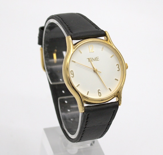 Vintage TIME wristwatch gold tone case white analog dial electronic quartz movement with black leather strap band 1980s fashion watch