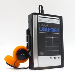 Vintage 1980s Sony Walkman stereo cassette tape player FM/AM radio black and chrome blue logo with WM headphones Japan