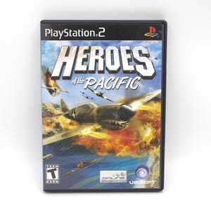 May include: A PlayStation 2 video game case for "Heroes of the Pacific." The cover art features a World War II-era airplane in flight over the ocean, with the game's title in large, bold letters. The case is black with the PlayStation 2 logo.