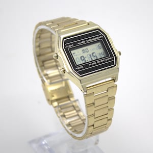 Vintage 1980s digital watch polished gold tone case adjustable stainless-steel band LCD quartz time chronograph calendar light 80s fashion