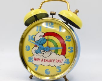 Vintage Smurf dual bell alarm clock analog spring wound mechanical "Have a Smurfy Day" cute bright yellow and blue metal Bradley USA