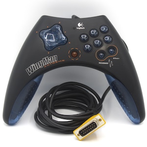 May include: Black Logitech WingMan Extreme game controller with blue accents and a black cable. The controller has multiple buttons, a directional pad, and the WingMan Extreme logo. The cable has a yellow connector.