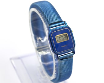 Vintage 1980s digital watch LCD quartz metallic blue case and elastic band mod minimalist design 80s fashion wristwatch