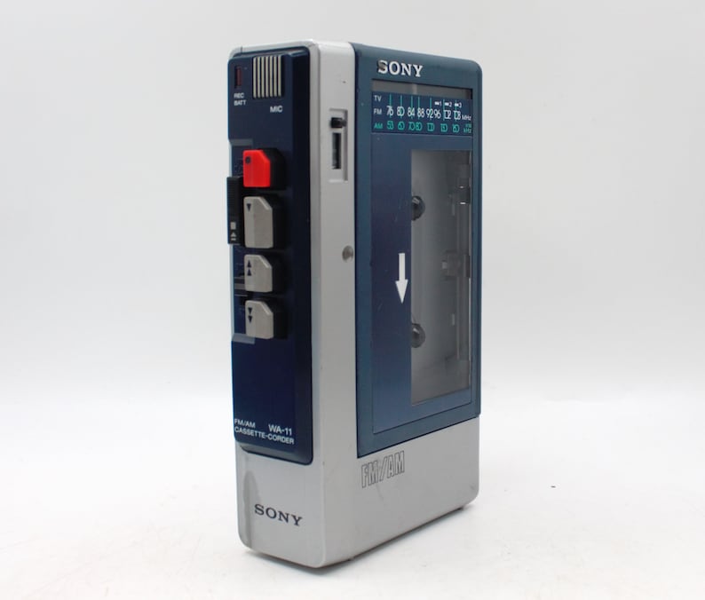 May include: A vintage Sony FM/AM cassette recorder, model WA-11, in a blue and gray color scheme. Features a clear cassette compartment, a radio dial, and control buttons. The recorder has the Sony logo on the front.