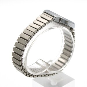 May include: A silver-toned wristwatch featuring a rectangular case and a flexible, expandable metal link bracelet. The watch has a brushed metallic finish on the band and a smooth, polished casing, presented from a side angle to show the structure.