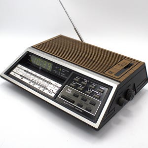 Vintage GE digital alarm clock radio green LED light time display and am/fm tuner dial woodgrain mod 70s wedge design General Electric