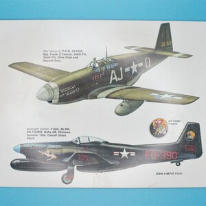 May include: Two illustrations of vintage military aircraft. The top image shows a green and brown P-51 Mustang fighter plane with the text "AJ--0" and "36 322". The bottom image shows a black F-82 Twin Mustang fighter plane with the text "FG-390" and "6390".