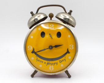 Vintage smiley face dual bell alarm clock Have a Happy Day bright yellow red chrome mechanical spring wound ringer nightstand Lux