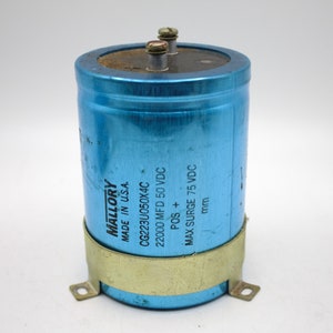 May include: A cylindrical blue Mallory capacitor with two screw terminals on top. The capacitor has a metal band and text that reads "MADE IN U.S.A.", "CG223U050X4C", "22000 MFD 50 VDC", and "MAX SURGE 75 VDC".