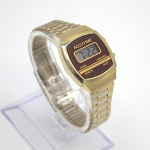 Vintage 1980s digital watch Accutime gold tone polished finish with adjustable stainless-steel band calendar 80s fashion quartz wristwatch